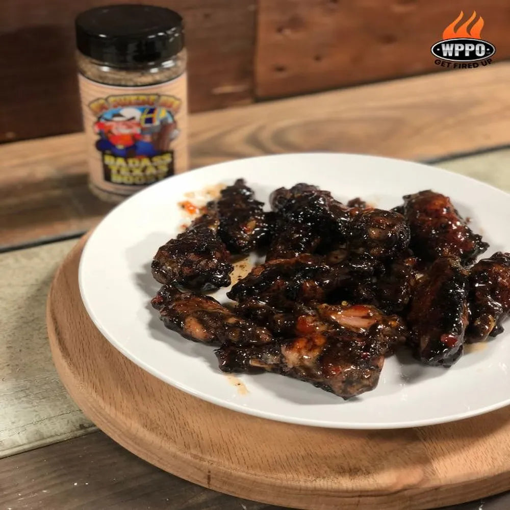 WPPO wood-fired chicken wings seasoned with Badass Texas Boost rub on a white plate.