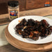 WPPO wood-fired chicken wings seasoned with Badass Texas Boost rub on a white plate.