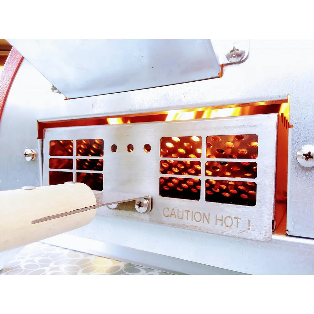 WPPO Le Peppe red wood-fired pizza oven including a pizza stone and essential cooking accessories.
