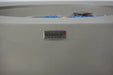 Close-up of Elementi “The Art of Living” logo badge on light gray Colosseo fire table
