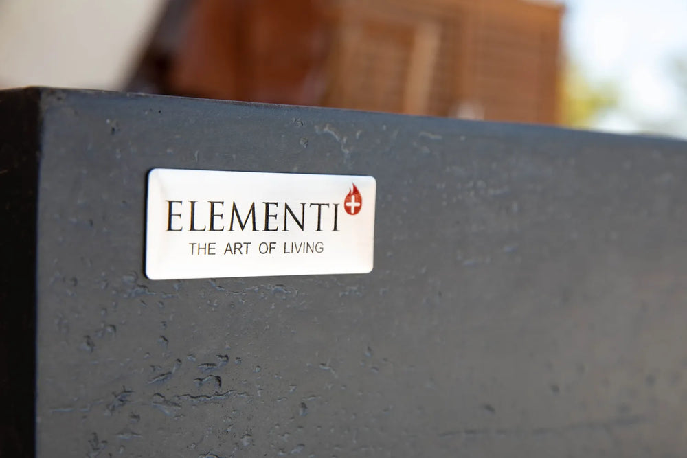 Elementi logo badge on dark gray concrete-style fire table surface.