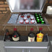 Sunstone heavy-duty stainless speed rail shelf holding liquor bottles below open ice chest, outdoor bar storage and organizer.