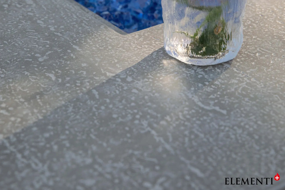 Close-up of light gray concrete-style finish on Elementi Plus Riviera fire table.