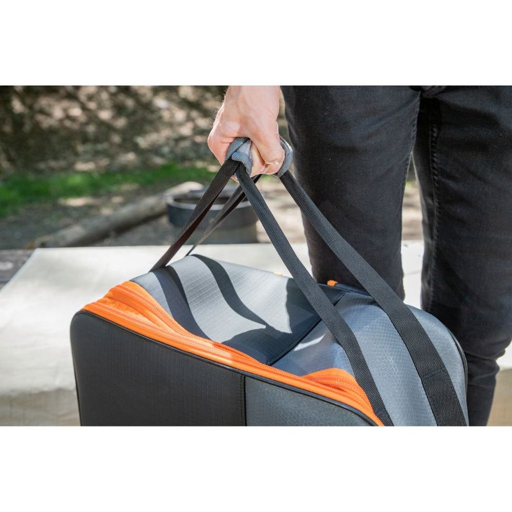 Person Holding the Top Handle of the Blackstone Tabletop Griddle Backpack – Lightweight and Travel-Friendly Design for Camping