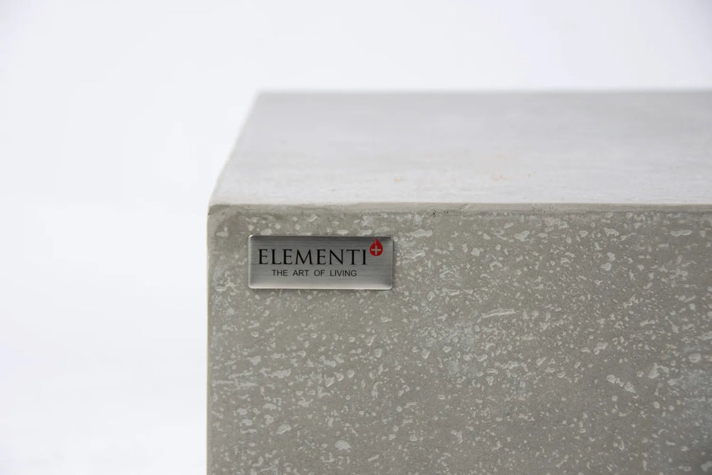 Elementi logo badge on light gray concrete-style fire table corner.