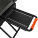 Close-up of Blackstone griddle side shelf with orange handle and steel vented tray for outdoor cooking