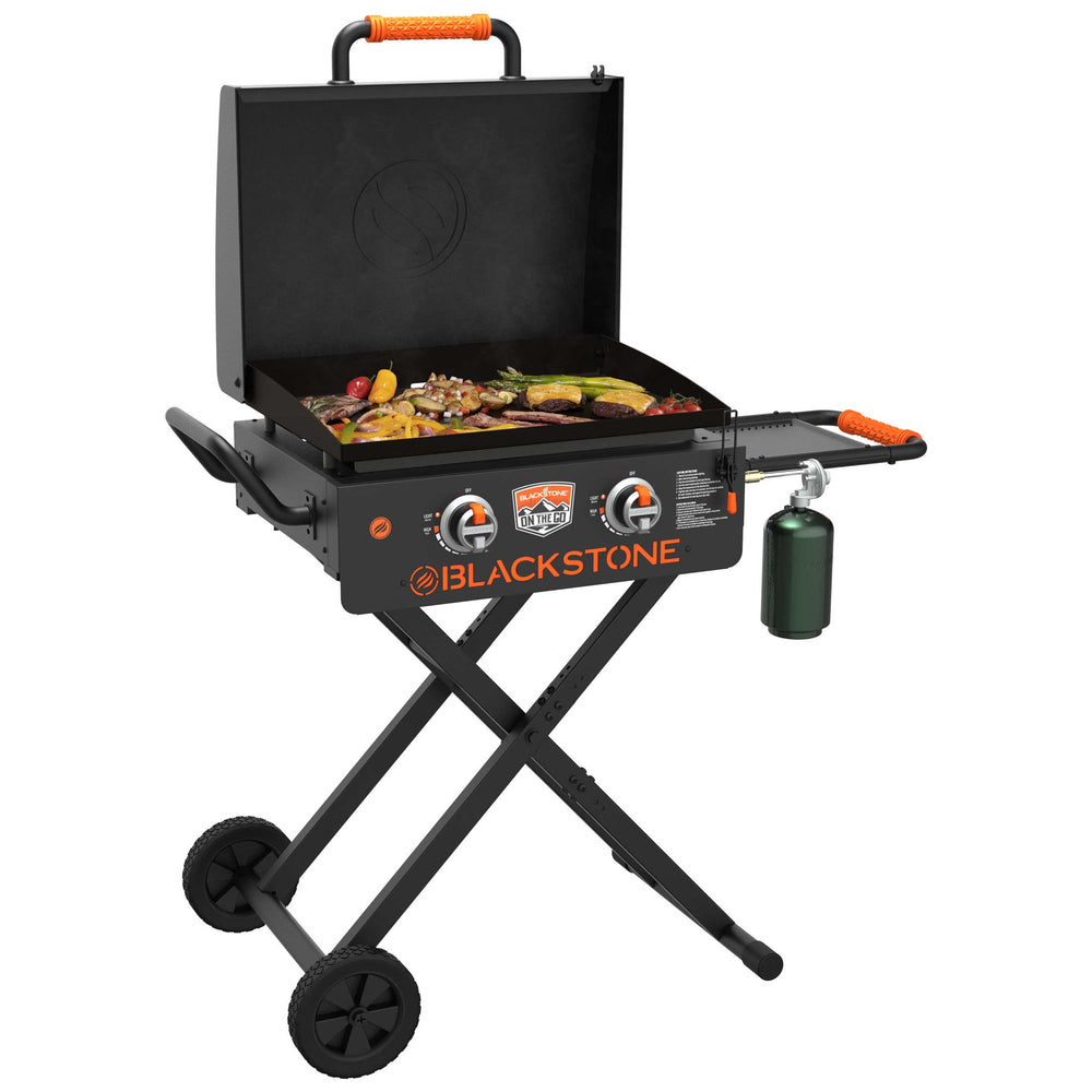 Blackstone On The Go gas griddle cooking grilled vegetables and steak on outdoor propane flat top grill