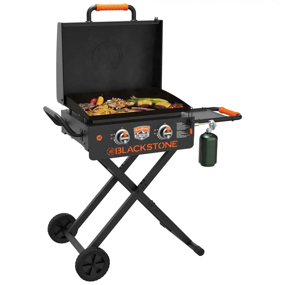 Blackstone On The Go gas griddle cooking grilled vegetables and steak on outdoor propane flat top grill