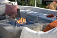 Close-up of Victoria fire table glass wind guard and space gray GFRC texture.