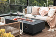 Rooftop patio featuring Elementi Granville OFG121DG Fire Table 60" Dark Gray with glass wind guard and snacks.