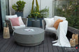 Elementi Plus Colosseo light gray round fire table with matching lid on modern outdoor balcony seating area.