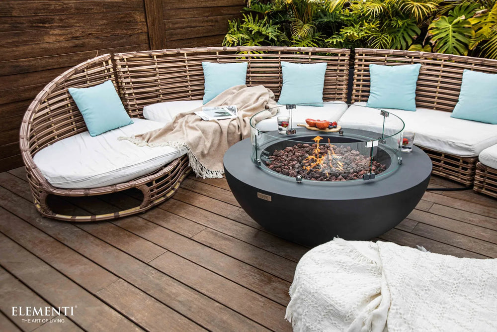 Elementi fire table on a beachfront wooden deck with turquoise pillows