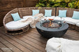Elementi fire table on a beachfront wooden deck with turquoise pillows
