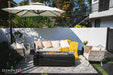 Elementi Plus OFP121BB Varna Bulgaria Black 60,000 BTU square fire table with a dark charcoal porcelain finish, styled on a luxury poolside patio with modern white lounge chairs.