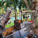 Tagwood BBQ06SS Santa Maria grill cooking meats over wood fire by waterfront backyard