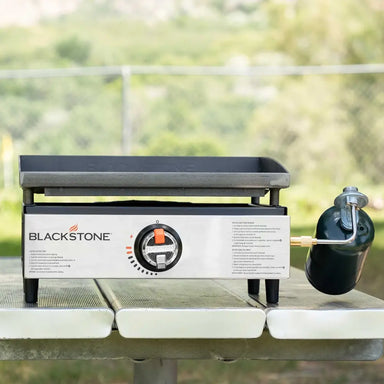 Front view of the Blackstone 17-inch portable propane tabletop griddle with stainless steel control panel, perfect for outdoor camping and backyard grilling.