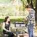 Couple enjoying outdoor cooking with the Blackstone 17" stainless steel tabletop griddle at a park, perfect for portable grilling and campsite meals.