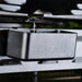 Close-up of Blackstone 17-inch griddle's rear grease management system with drip tray catching oil for easy cleanup