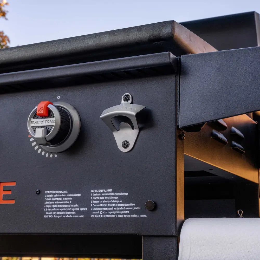 Close-up of Blackstone griddle burner control and integrated bottle opener – functional design for seamless outdoor cooking experience
