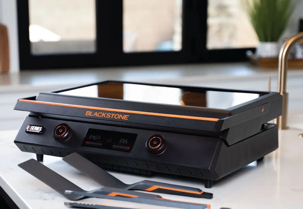 Blackstone E-Series 22-Inch Electric Tabletop Griddle with sleek black design and digital control knobs on kitchen countertop