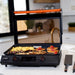 Blackstone 22-Inch E-Series Electric Griddle with glass lid open, cooking breakfast items including sausages, hash browns, and pancakes