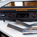 Blackstone E-Series electric griddle with dual spatulas and tongs on counter, showing precision digital controls