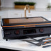 Front view of Blackstone 22-Inch electric griddle with glossy ceramic lid closed, showing two digital temp zones and cooking tools