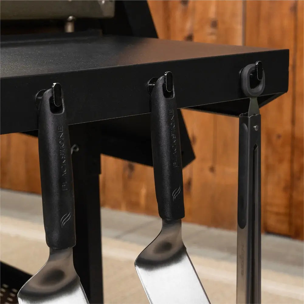 Close-Up of Blackstone Griddle Side Hooks Holding Stainless Steel Cooking Utensils – Outdoor BBQ Tool Storage