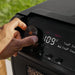 Detailed view of Blackstone Smoker Air Fryer Combo control panel with dials for temp and timer settings
