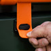 Close-up of secure orange latch on the Blackstone griddle hood for travel-ready locking mechanism