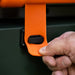 Close-up of secure orange latch on the Blackstone griddle hood for travel-ready locking mechanism