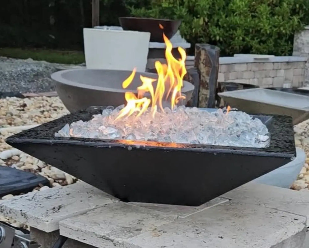 Travertine TessaRai 36 inch Square Fire Bowl Kit with clear fire glass and bright flames in outdoor showroom setting