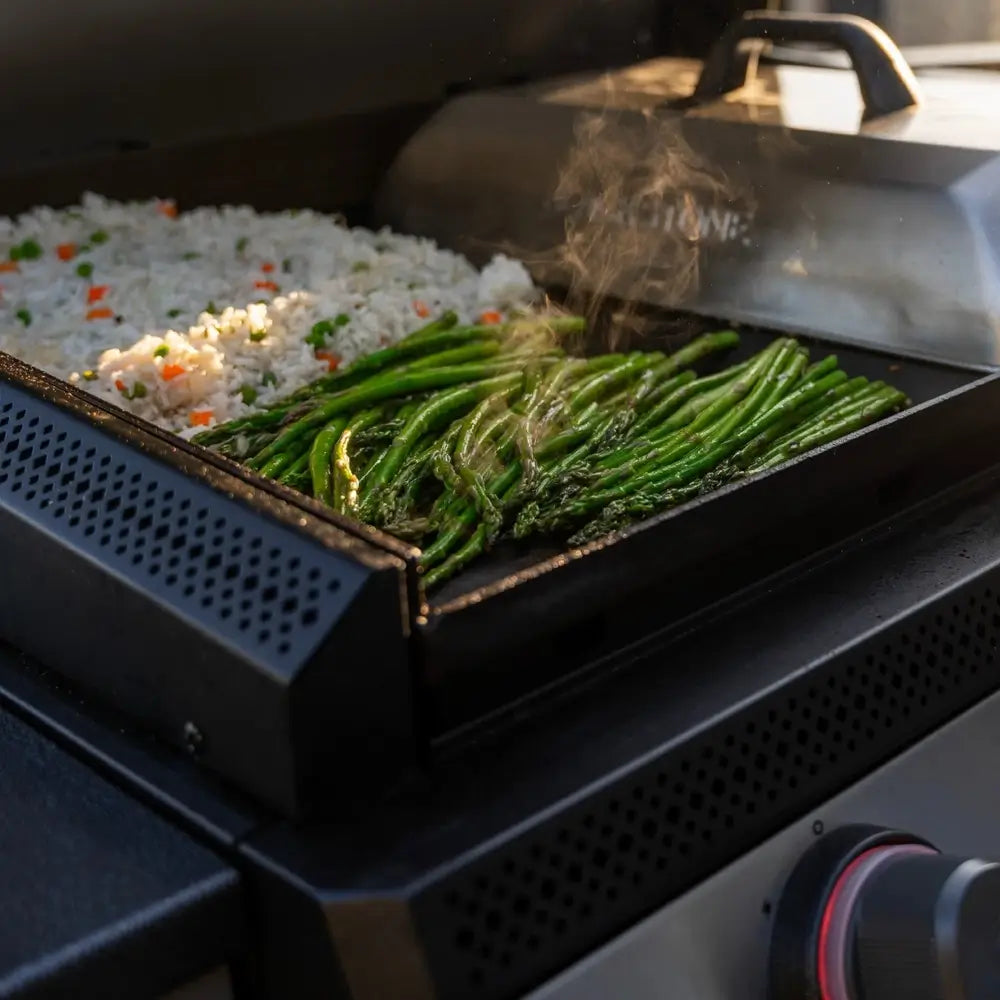  Close-up of vegetables and fried rice sizzling on Blackstone 28-inch stainless steel griddle surface