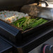  Close-up of vegetables and fried rice sizzling on Blackstone 28-inch stainless steel griddle surface
