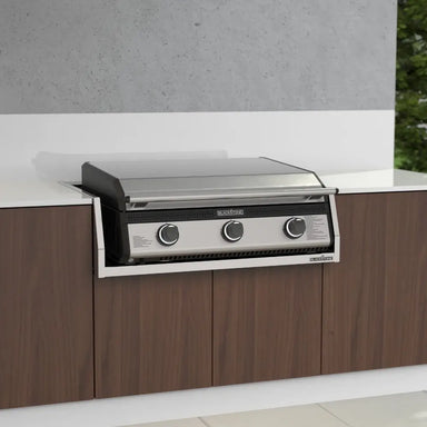 Front view of stainless steel 28-inch Blackstone drop-in griddle with hood built into modern outdoor kitchen