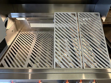 Interior view of the grill showing two KoKoMo LuxCut laser-cut cooking grates installed and two additional grate sections propped up, highlighting the modular design.
