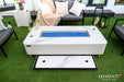 top-down view of the fire table on a patio, showing the matching marble-patterned lid stored in a sliding drawer that extends from underneath the table's main frame.