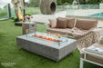 Elementi Hampton OFG139LG 56" Fire Table used as a functional coffee table for drinks and appetizers on a patio.