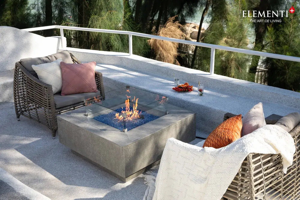 Modern outdoor lounge featuring the Victoria rectangular fire pit table and designer patio furniture.