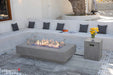 Elementi Plus Riviera light gray rectangular fire table in contemporary outdoor lounge setting.