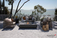 Elementi Plus Cannes 60-inch dark gray fire table on patio with ocean view and wicker furniture.