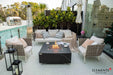 Elementi Plus OFP103BB Bulgaria Black 60,000 BTU fire table with a dark charcoal porcelain finish, styled on a luxury poolside patio with modern white lounge chairs.