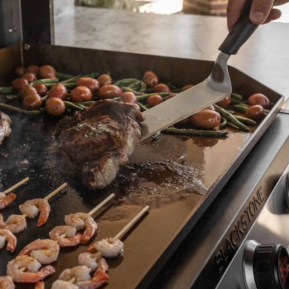 Grilling steak, shrimp skewers, and vegetables on Blackstone drop-in 36-inch griddle – Premium non-stick flat top for outdoor kitchens