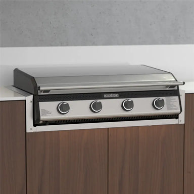 Front-facing stainless steel drop-in griddle installed in modern outdoor kitchen cabinetry