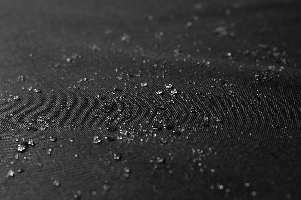 Water-resistant surface of the Blackstone 36-inch griddle cover with water droplets showing weatherproof capabilities