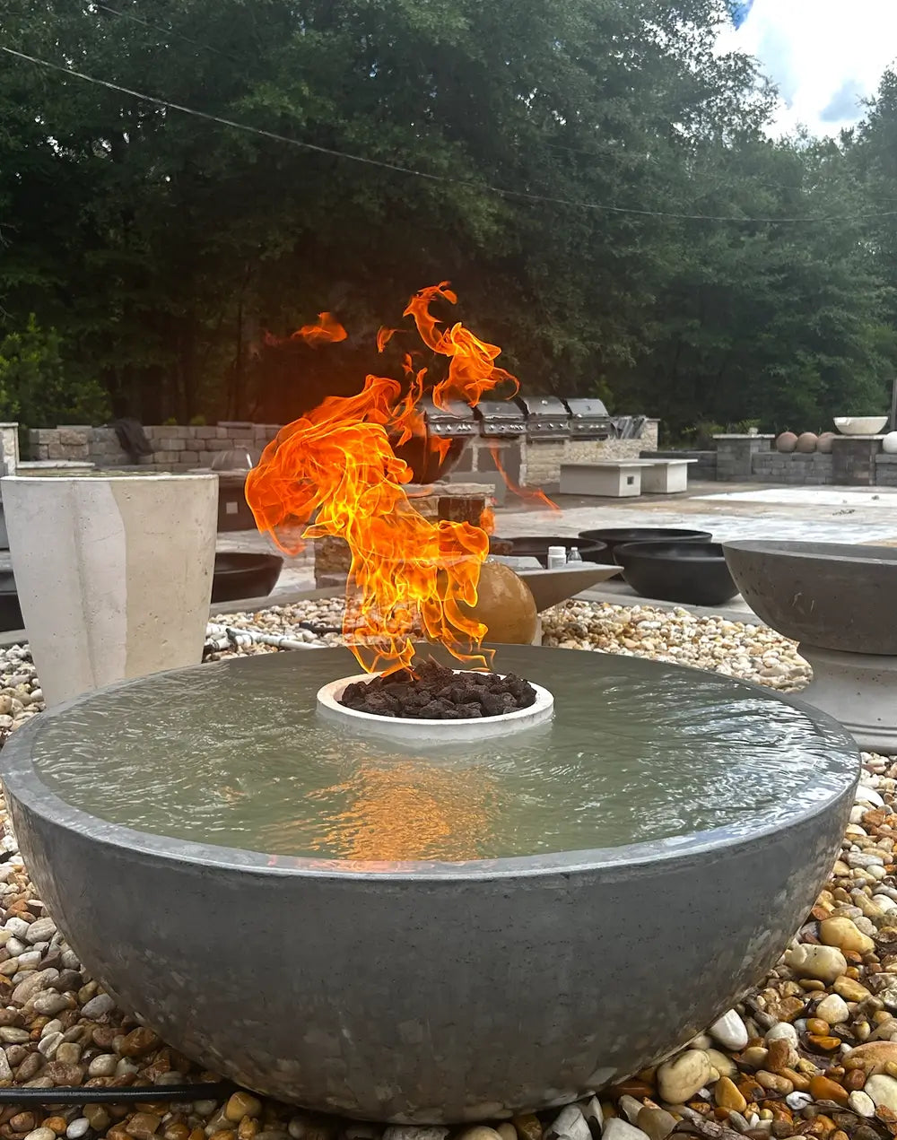 Close-up of an active TessaRai 360 fire and water bowl kit highlighting the dancing flames and lava rock center.