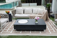 The Metropolis fire table used as a functional outdoor coffee table with a stainless steel lid and afternoon tea service.