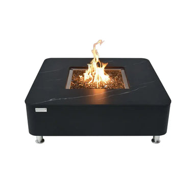 Elementi OFP101BB 60,000 BTU square porcelain fire table with active flame and bronze fire glass media.