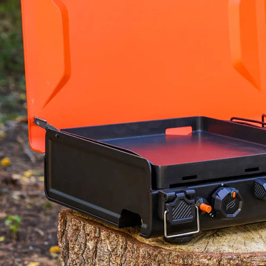 Close-up of non-stick griddle top with side handle for camping use