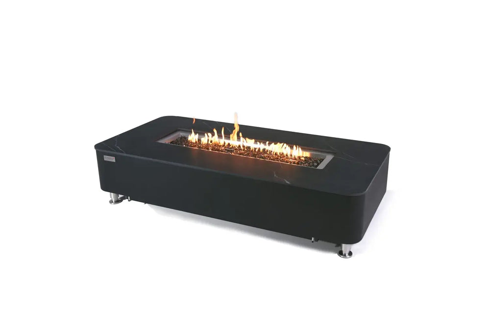 studio shot of the black marble-effect fire pit table against a plain white background, featuring a long, linear flame burning over dark glass media.